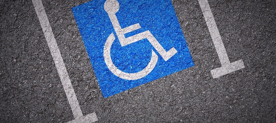 disabled parking symbol on road