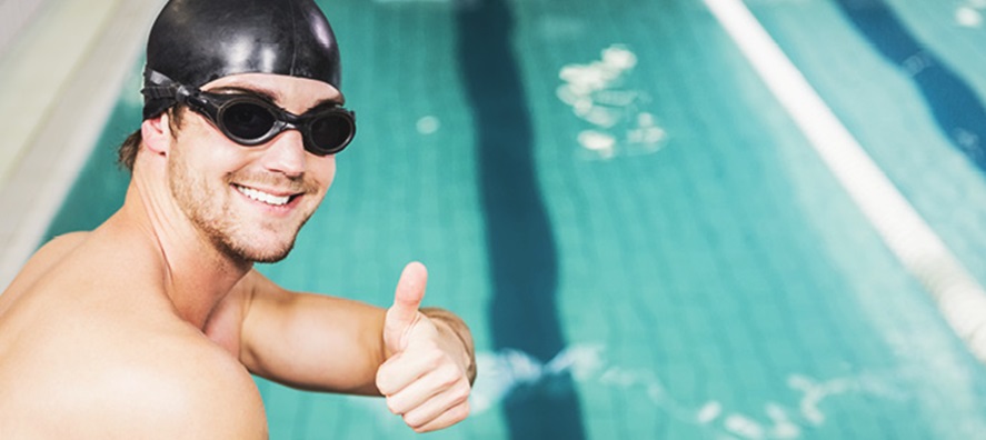 Man smiling with thumbs up at indoor pool HBF Stadium