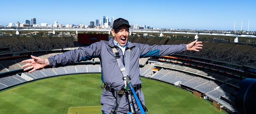 A close up shot of Mike McKenna suspended over the Optus Stadium field