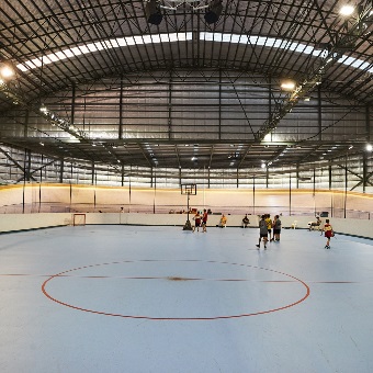 A ground level photo of people basketball on the multipurpose court in the centre of the Speeddome in Middle Swan, Perth