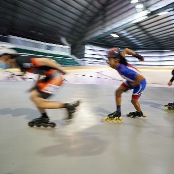 A photo of five participants engaging in speed hockey at the Speeddome in Middle Swan, Perth