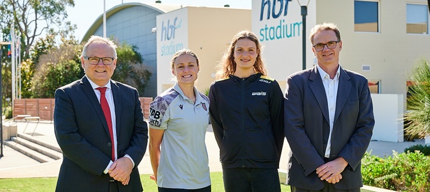 Photo of two men in suits with two VenuesWest brand ambassadors outside HBF Stadium in Mount Claremont, Perth