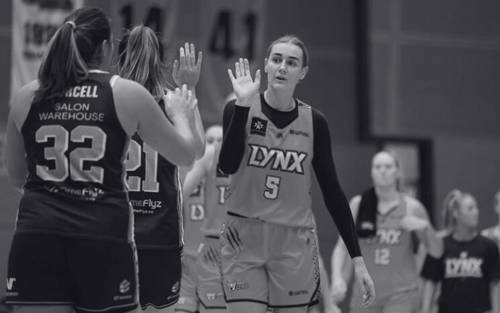 Photo of Darcee Garbin at Bendat Basketball Centre in Floreat, Perth Black and white photo of Darcee Garbin high fiving two teammates at Bendat Basketball Centre in Floreat, Perth