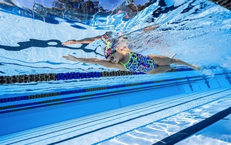 Underwater view of swimmer wearing Fiski goggles